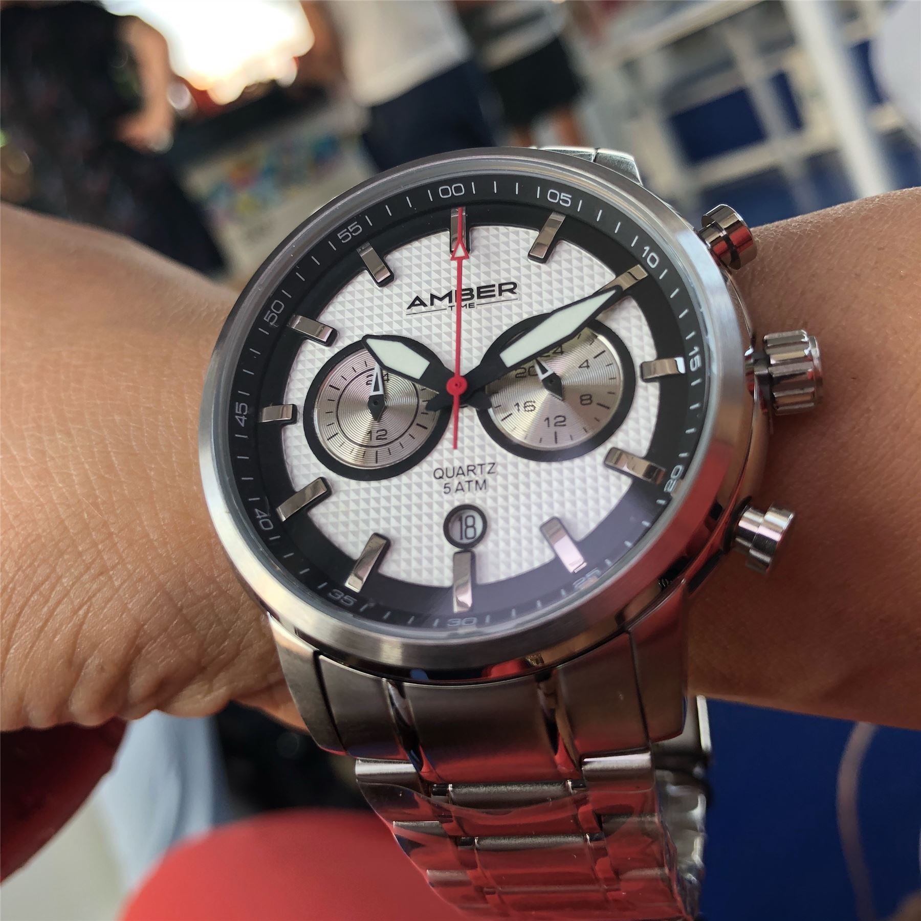 Amber Time Men's Quartz Chronograph Watch featuring a polished stainless steel case, white dial with date display, and secure stainless steel bracelet.