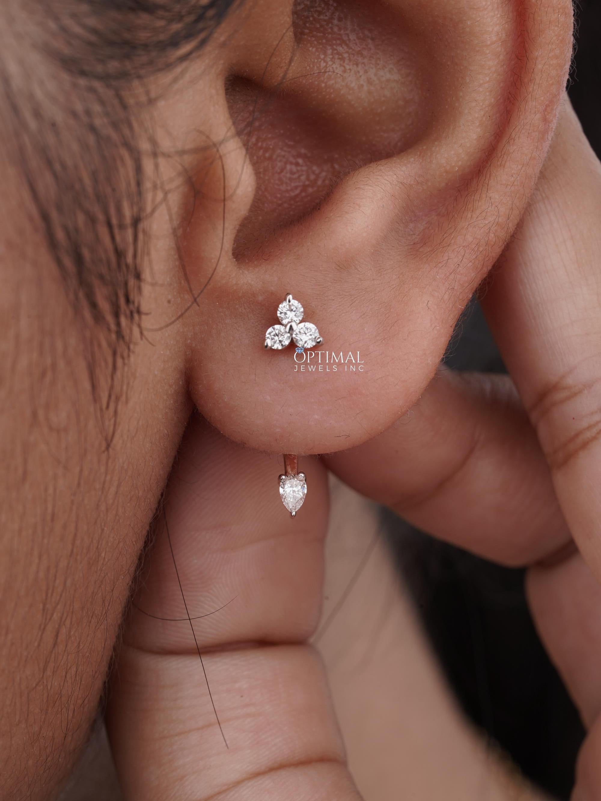 0.50 CTW Unique Rose Gold Earring featuring lab-grown diamonds in asymmetric design with round and pear-cut stones.