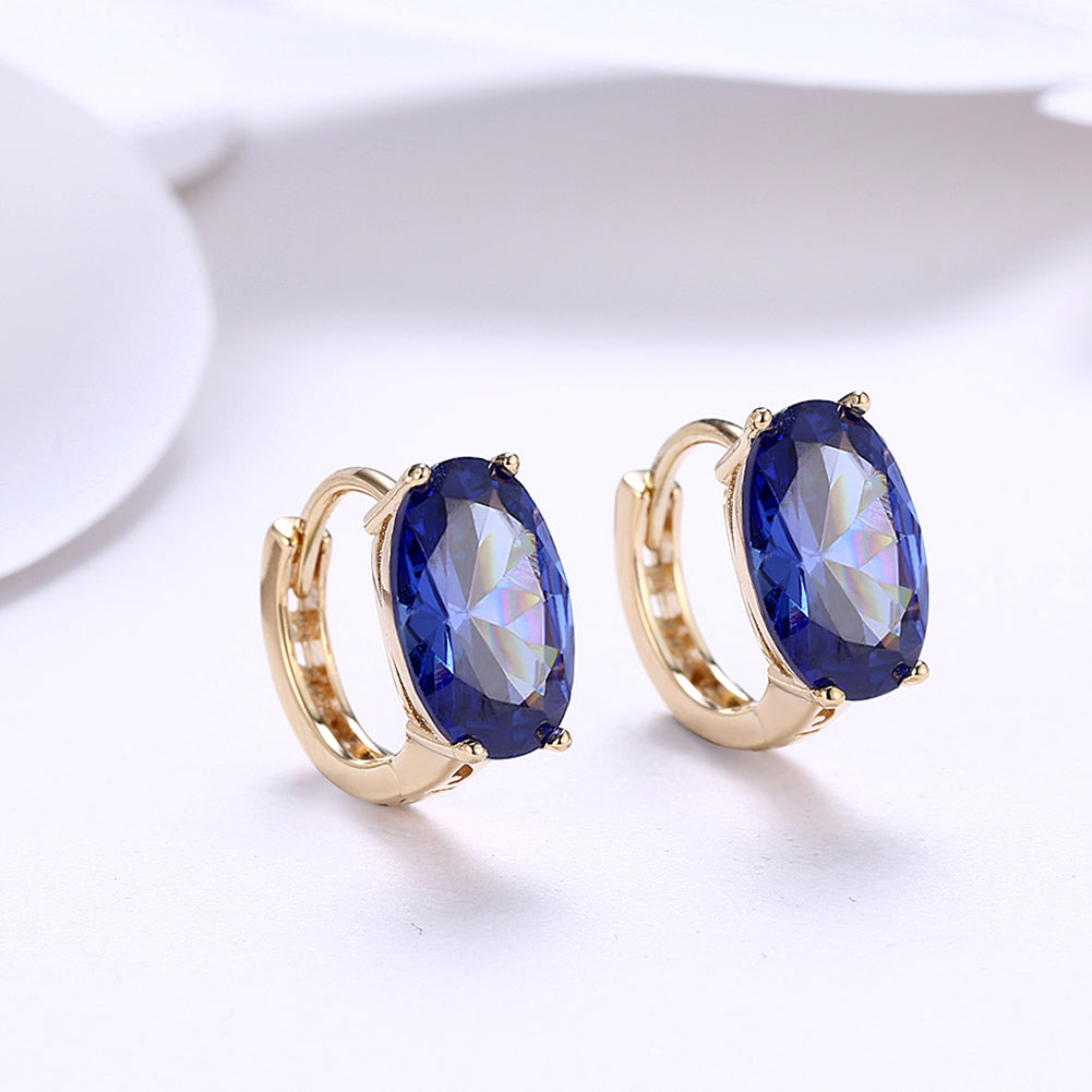 Elegant 1.00 Ct Sapphire Oval Cut Huggie Earring in 18K Gold Plated, showcasing a beautiful blue sapphire set in a gold-plated design.