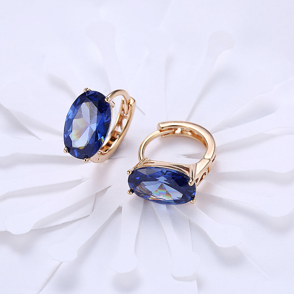 Elegant 1.00 Ct Sapphire Oval Cut Huggie Earring in 18K Gold Plated, showcasing a beautiful blue sapphire set in a gold-plated design.