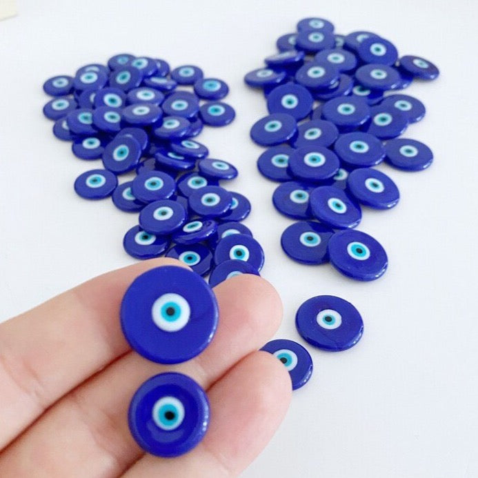 A collection of 10 handmade blue evil eye beads made from Murano glass, showcasing vibrant blue colors and intricate designs in 15mm and 20mm sizes.