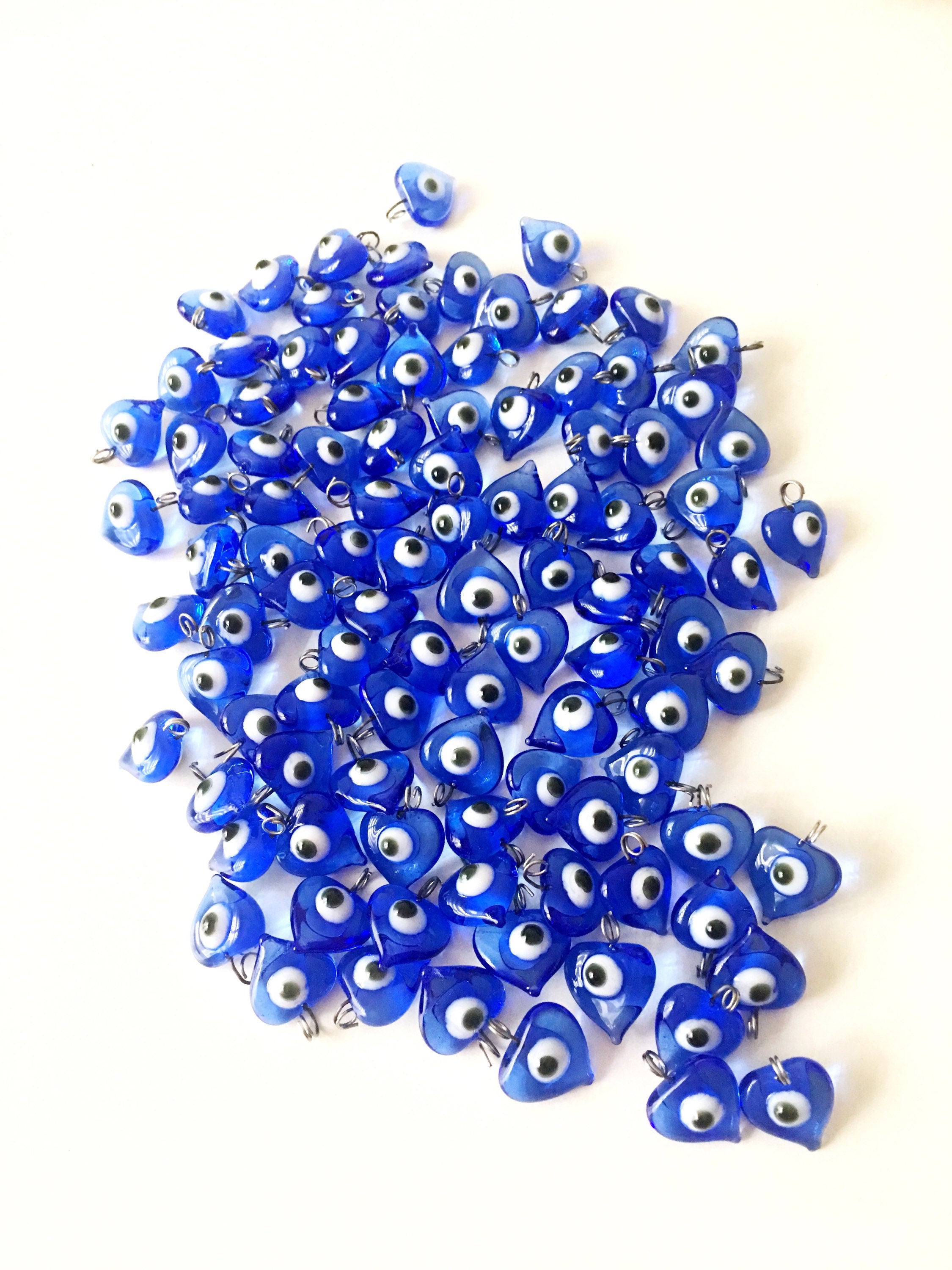 A collection of 10 blue glass evil eye charms with metal hooks, symbolizing protection and good luck, ideal for wedding favors and DIY jewelry.