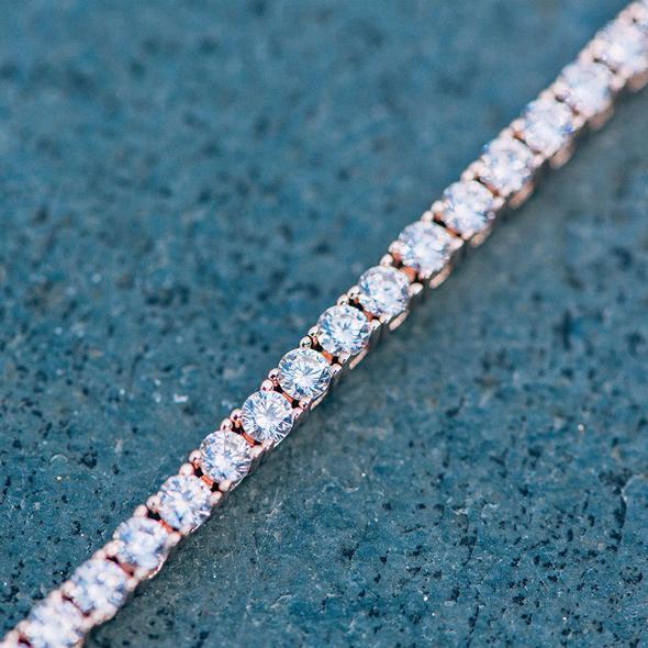 A luxurious 5-piece jewelry set featuring a tennis bracelet, halo earrings, and a necklace, all adorned with sparkling Austrian crystals and rose gold plating.