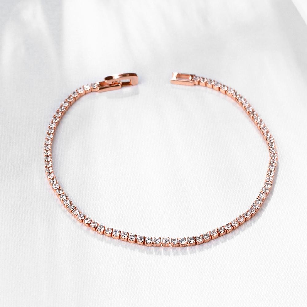 A luxurious 5-piece jewelry set featuring a tennis bracelet, halo earrings, and a necklace, all adorned with sparkling Austrian crystals and rose gold plating.
