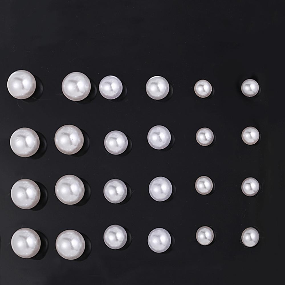 A beautiful 12 piece set of graduating pearl stud earrings, elegantly displayed, featuring 18K white gold plating for a luxurious finish.