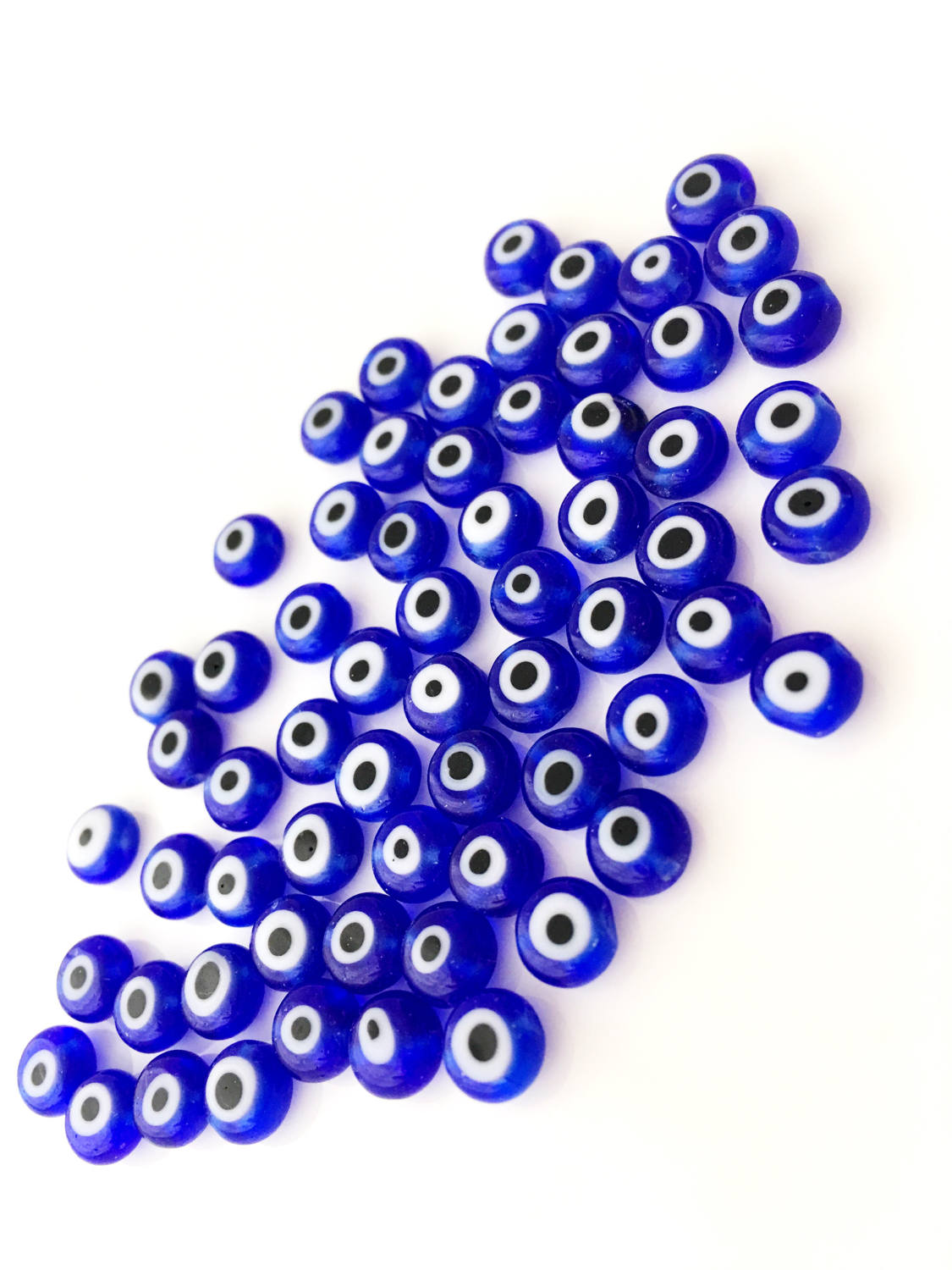 A collection of 120 blue glass evil eye beads in various sizes from 6mm to 12mm, showcasing their unique handmade designs.