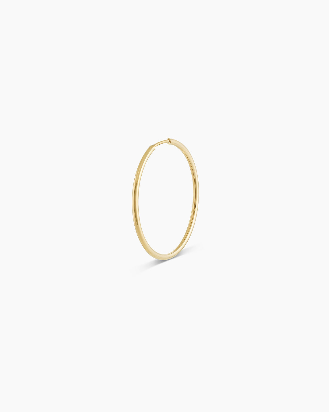 A pair of elegant 14k gold classic hoop earrings, showcasing their radiant shine and timeless design.