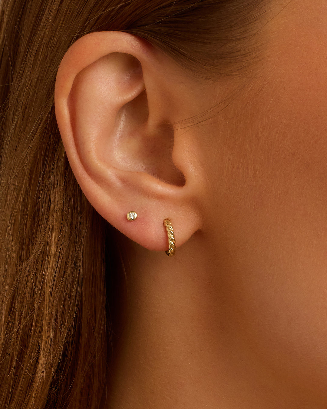 Elegant 14k Gold Crew Helium Huggies earrings, showcasing a lightweight and luxurious design perfect for everyday wear.
