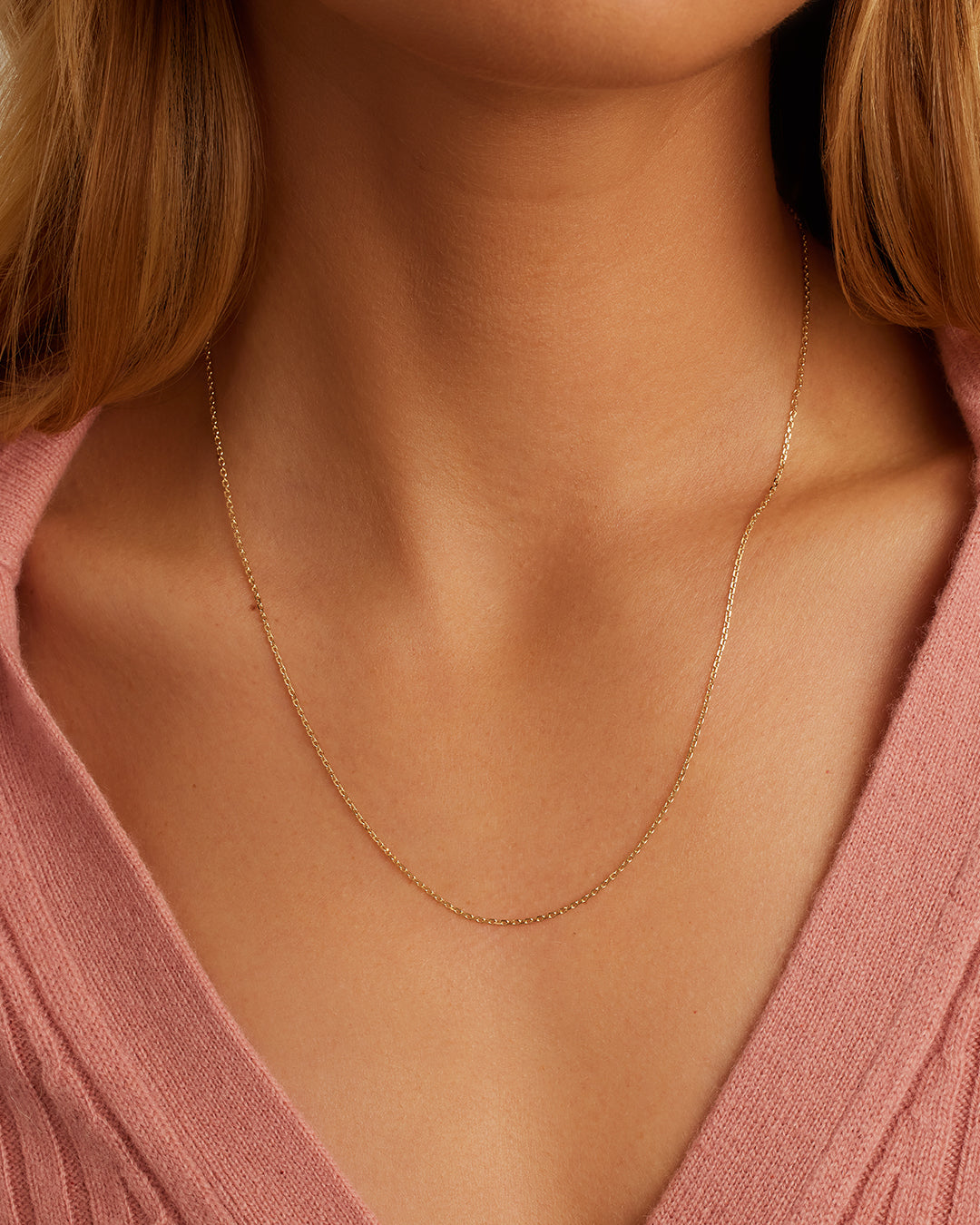 14k Gold Delicate Link Chain showcasing its elegant and delicate design, perfect for layering or wearing alone.