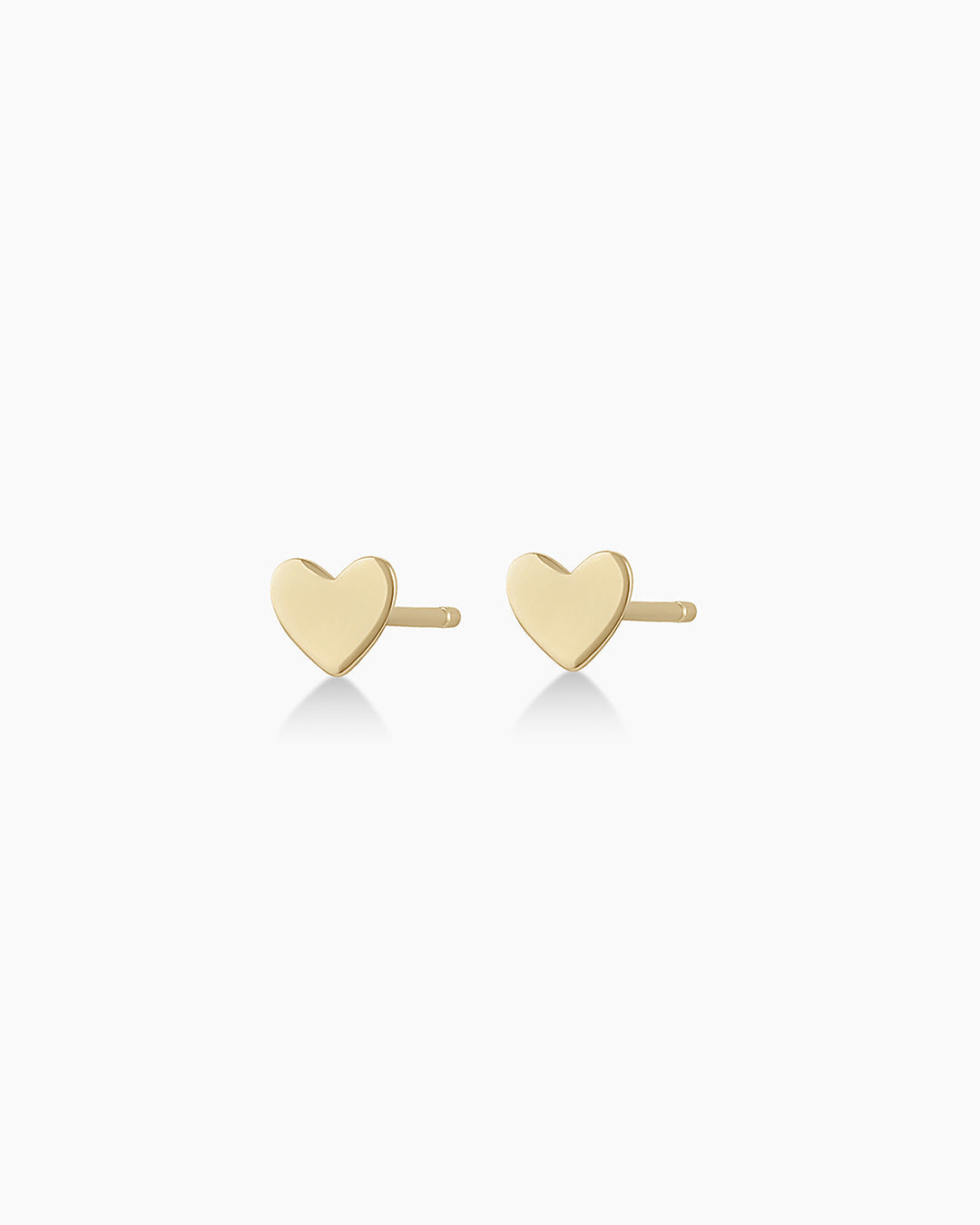 A pair of elegant 14k gold heart stud earrings, showcasing their shiny finish and classic heart shape.