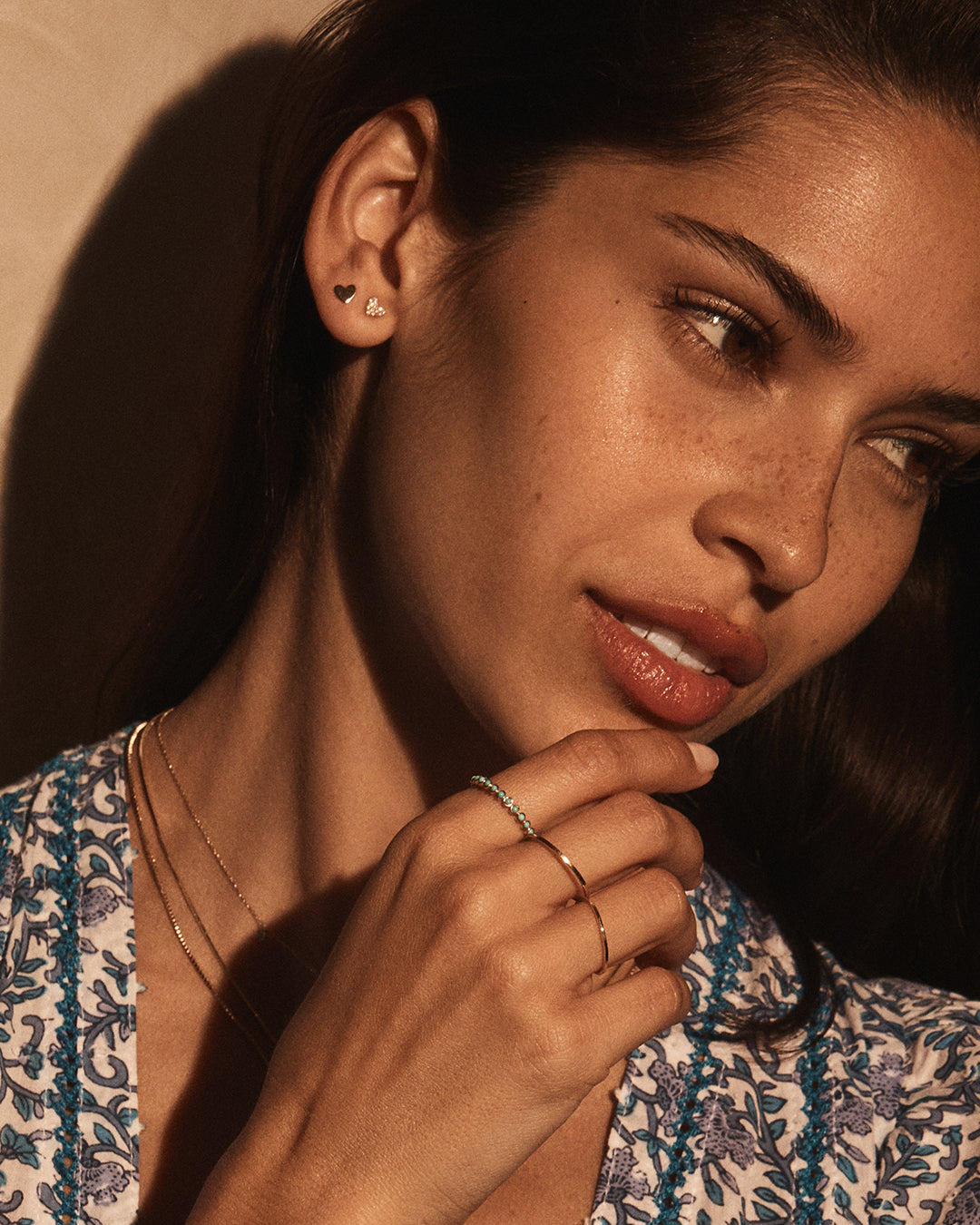 A pair of elegant 14k gold heart stud earrings, showcasing their shiny finish and classic heart shape.