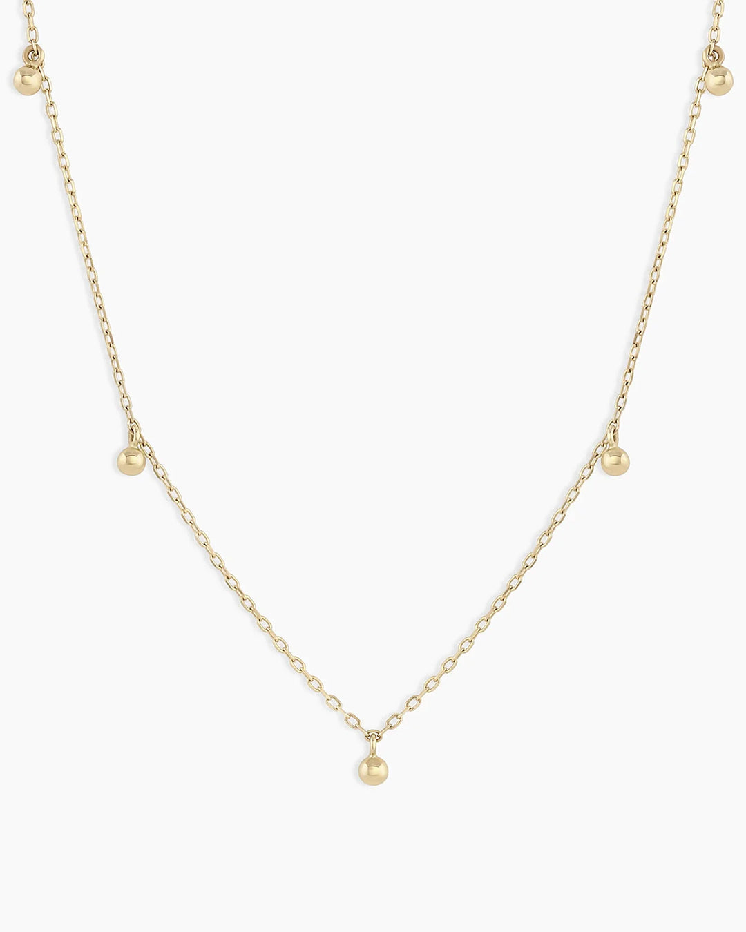Elegant 14k Gold Newport Flutter Necklace with dainty beads on an adjustable chain, showcasing its intricate design.