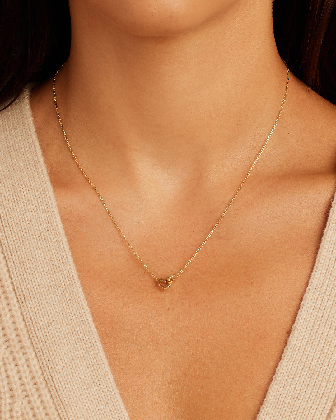 A beautiful 14k gold necklace featuring a unique heart design, perfect for adventurous spirits.