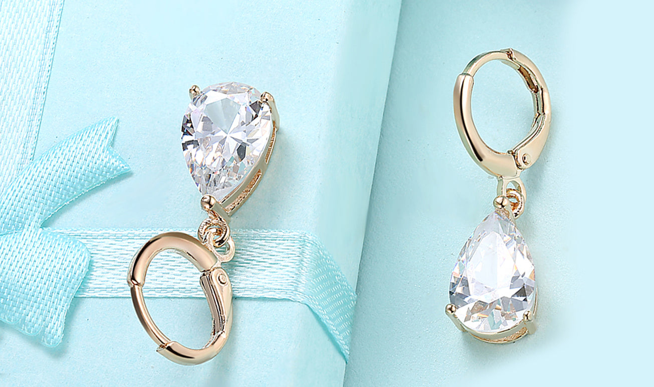 Elegant 14K gold plated pear cut drop earrings in blue, purple, and white options, showcasing their sleek design and high-quality craftsmanship.