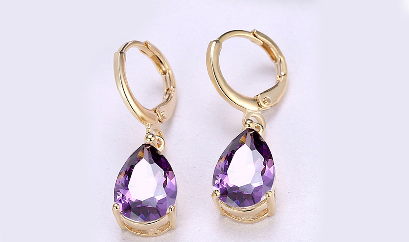 Elegant 14K gold plated pear cut drop earrings in blue, purple, and white options, showcasing their sleek design and high-quality craftsmanship.