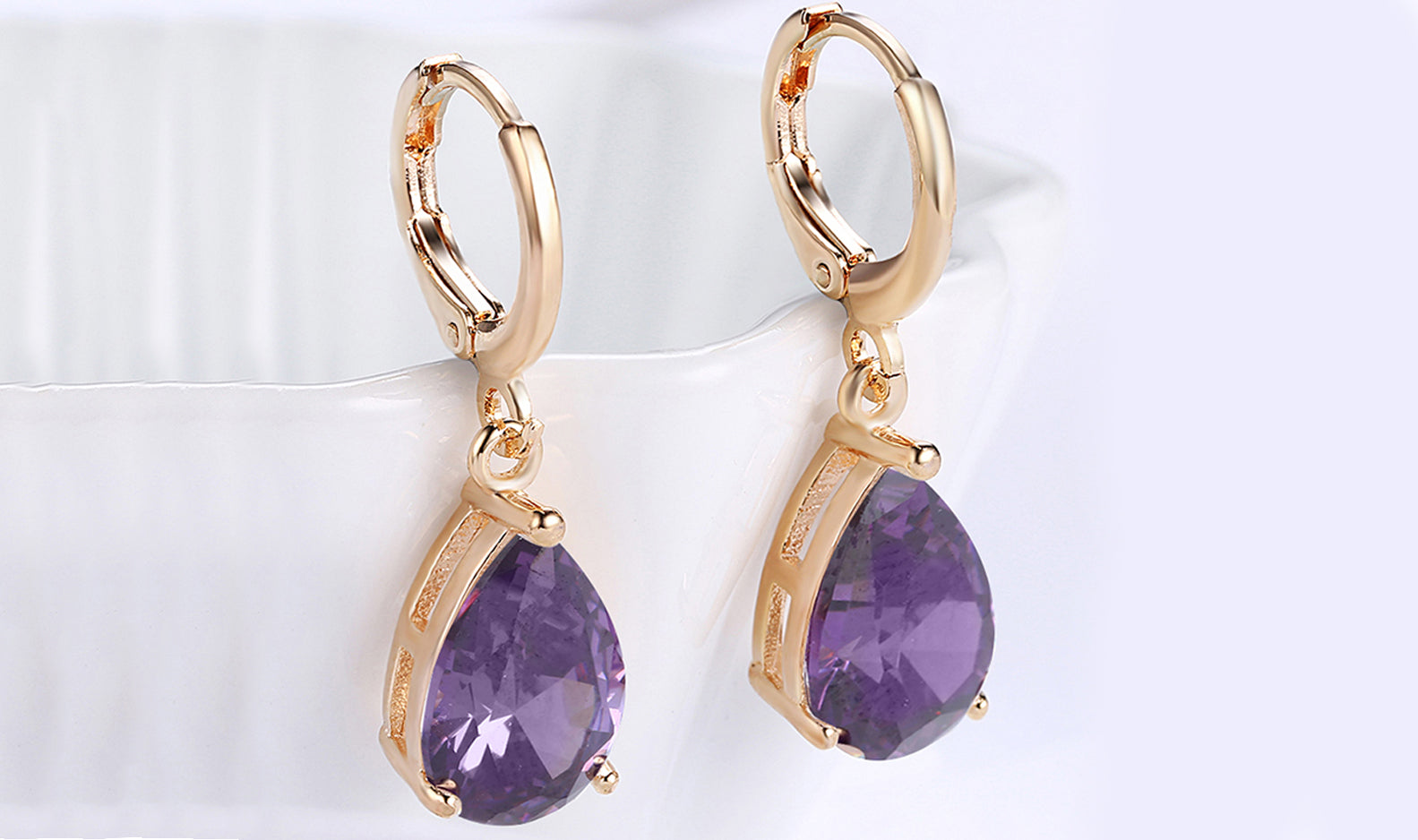 Elegant 14K gold plated pear cut drop earrings in blue, purple, and white options, showcasing their sleek design and high-quality craftsmanship.