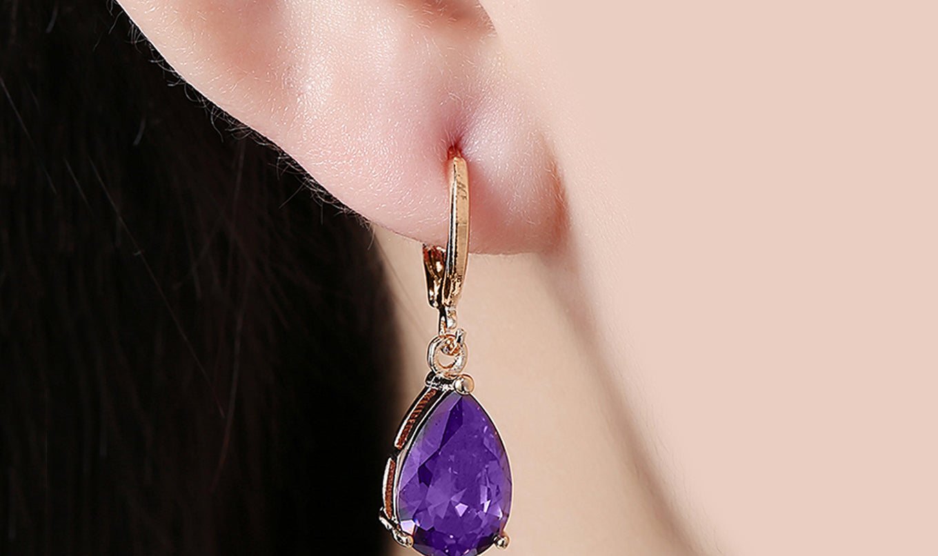 Elegant 14K gold plated pear cut drop earrings in blue, purple, and white options, showcasing their sleek design and high-quality craftsmanship.