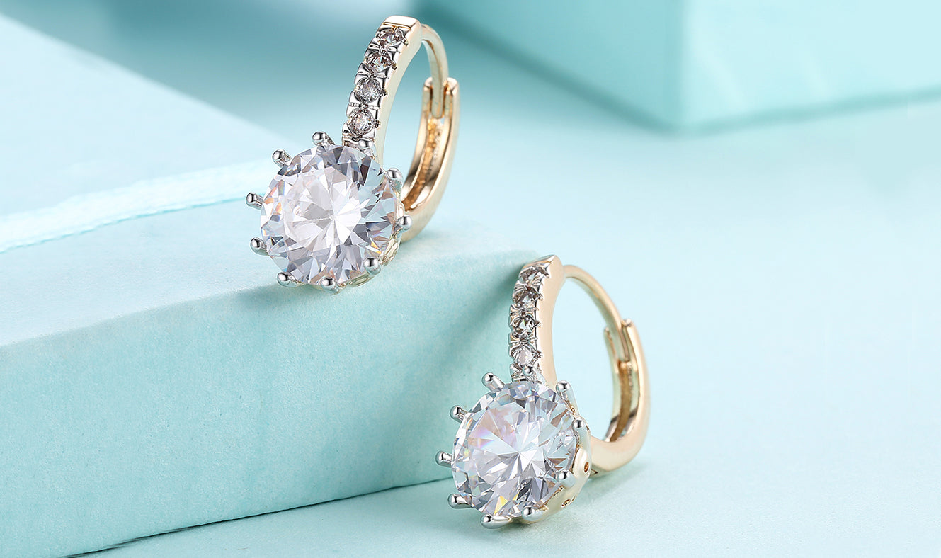 Elegant 14K gold plated lever back earrings featuring white sapphire stones in a starburst design, perfect for any occasion.