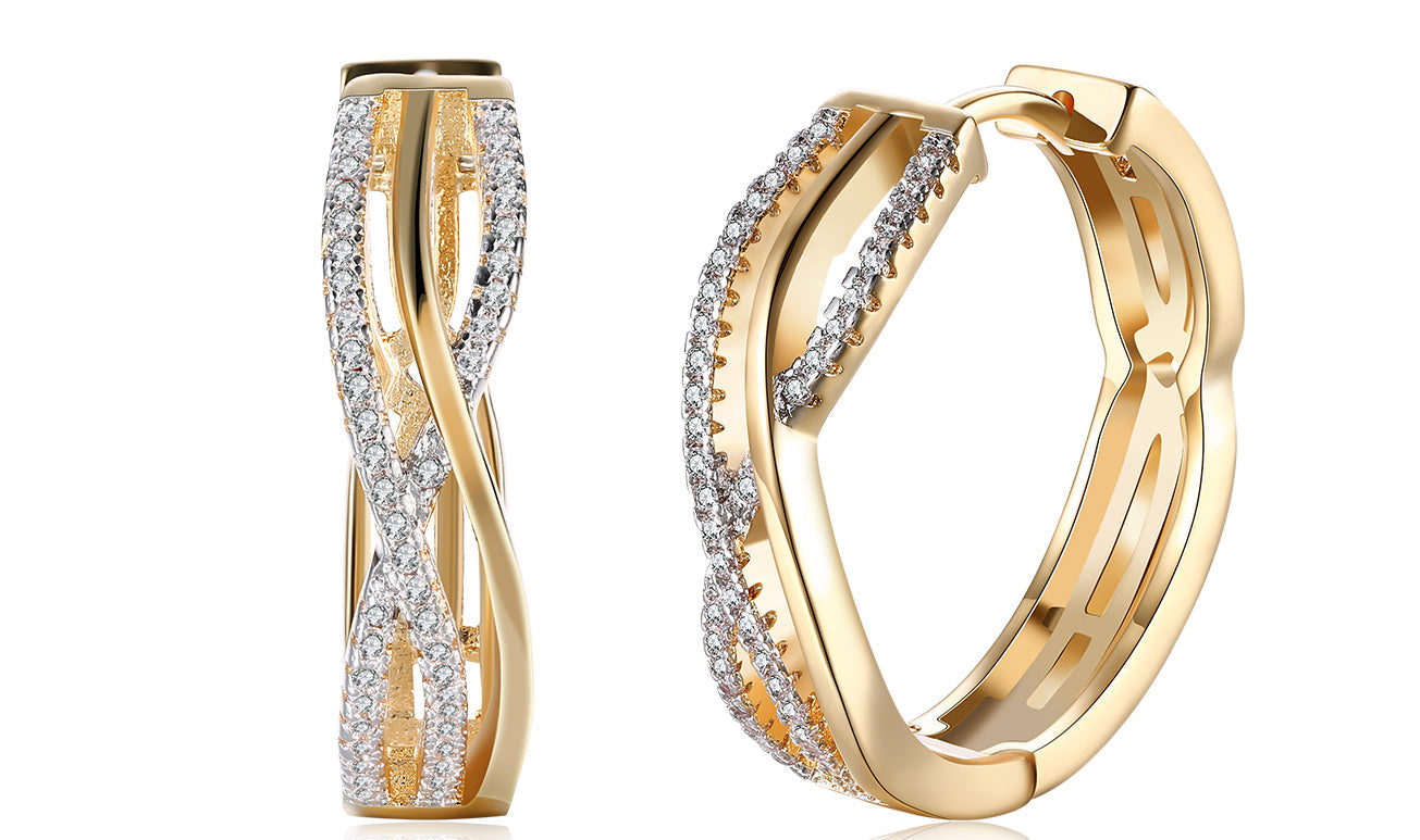 Elegant 14K gold plated clip-on earrings featuring white sapphire stones in a twisted abstract design.
