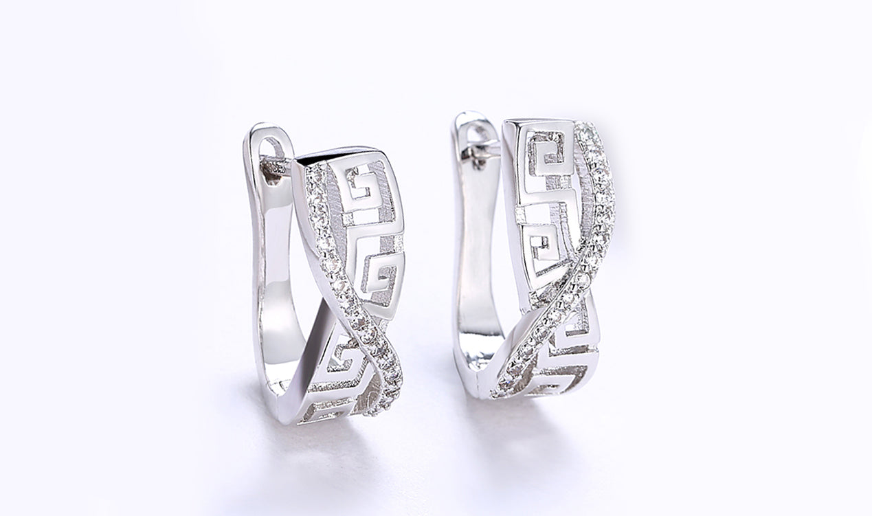 Elegant 14K white gold plated earrings featuring white sapphire stones in a Greek key design, showcasing a curved hinged style.