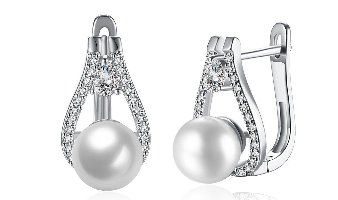 Elegant 14K white gold plated clip-on earrings featuring Austrian elements stones and freshwater pearls in a pear cut design.