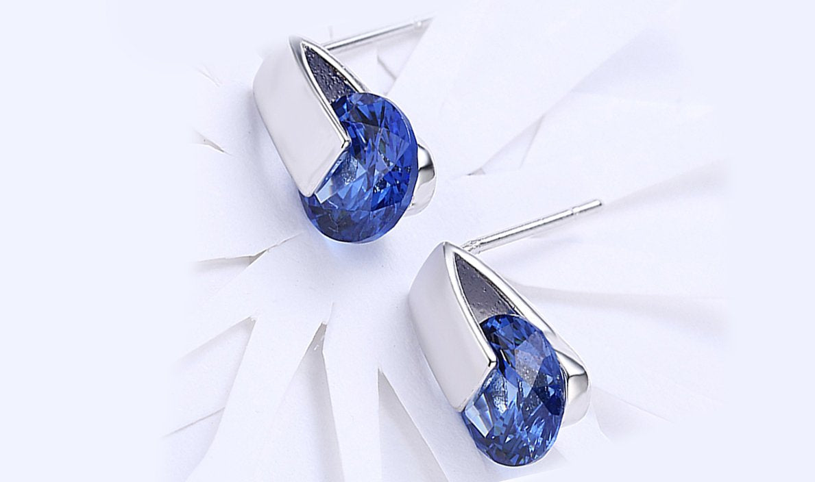Elegant 14K white gold plated earrings featuring blue Austrian elements, designed as stylish stud earrings.