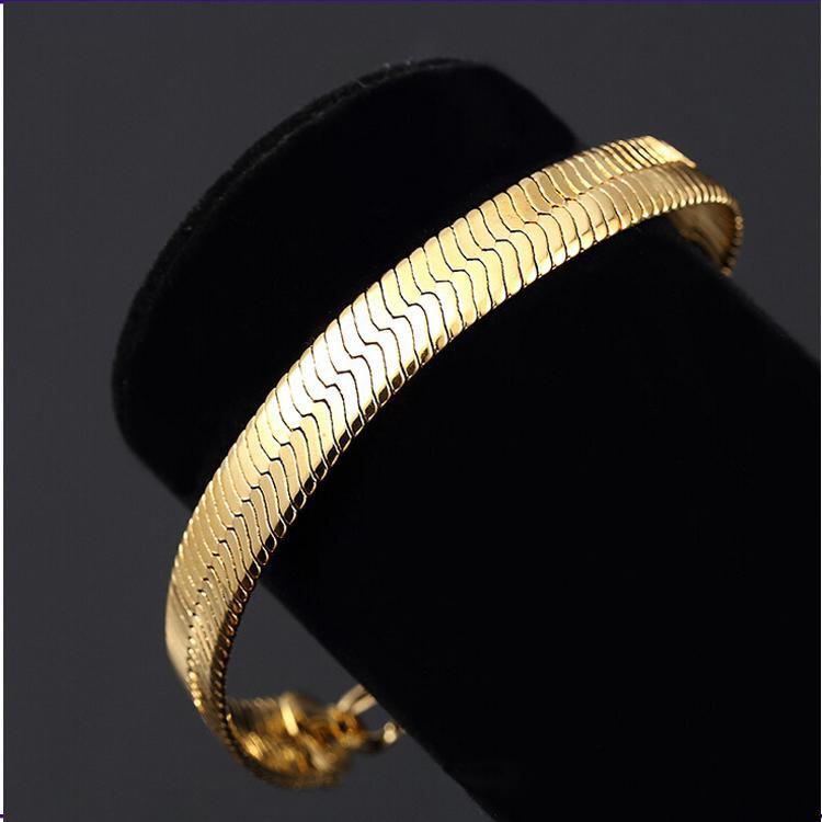 Elegant 14K yellow gold plated classic herringbone bracelet showcasing a beautiful pattern and luxurious shine.