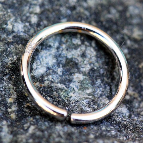 A 14Kt white gold seamless ring with a smooth round design, ideal for various piercings including nose and cartilage.