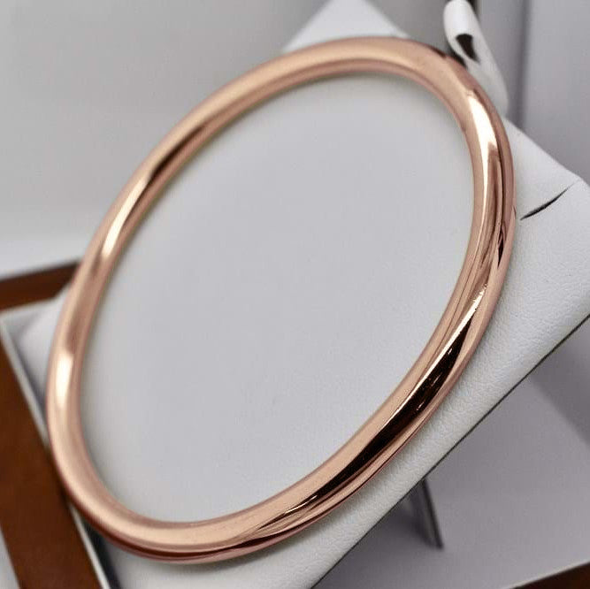 18ct Heavy Rose Gold Plated Classic Wide Solid Golf Bangle displayed elegantly, showcasing its shiny finish and classic design.