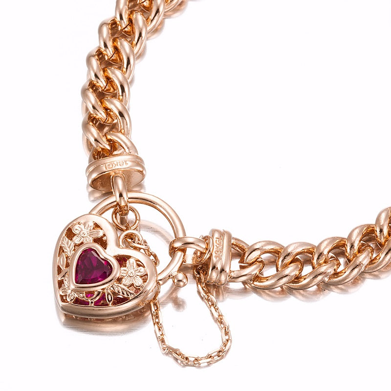 Elegant 18ct Heavy Rose Gold Plated Euro Chain Bracelet featuring a filigree locket and simulated ruby, showcasing its intricate design.