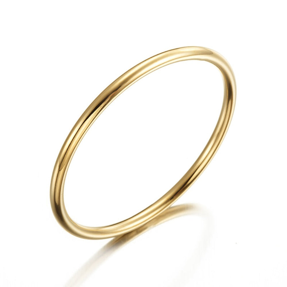 A beautiful 18ct heavy yellow gold plated children's golf bangle, showcasing its shiny finish and elegant design, available in two sizes.