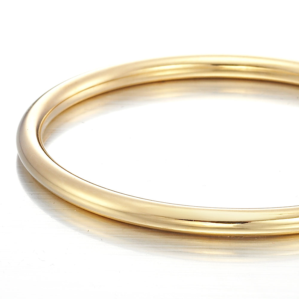 A beautiful 18ct heavy yellow gold plated children's golf bangle, showcasing its shiny finish and elegant design, available in two sizes.