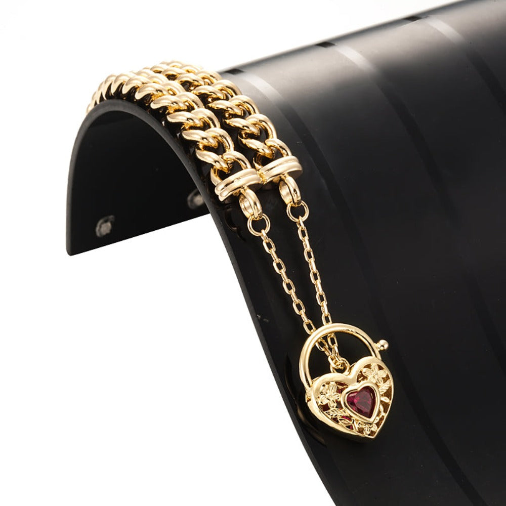 18ct Heavy Yellow Gold Plated Euro Chain Bracelet featuring a filigree locket and simulated ruby, showcasing intricate design and luxurious finish.
