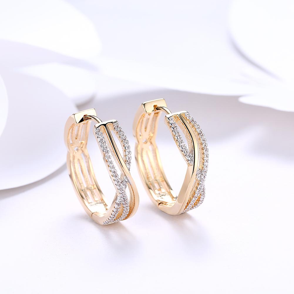 Elegant 18K gold plated criss cross pav'e earrings adorned with white Elements crystals, showcasing a modern design.