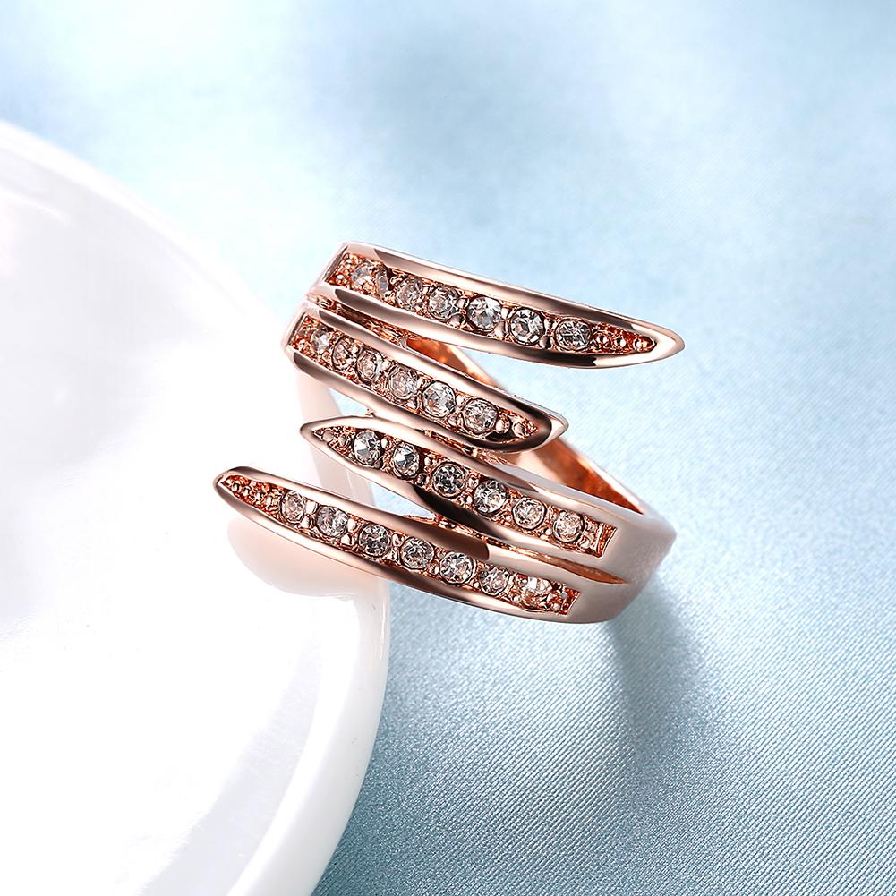 Elegant 18K rose gold plated Elements Ariana Ring featuring a curved design and white AAAAA quality stones.