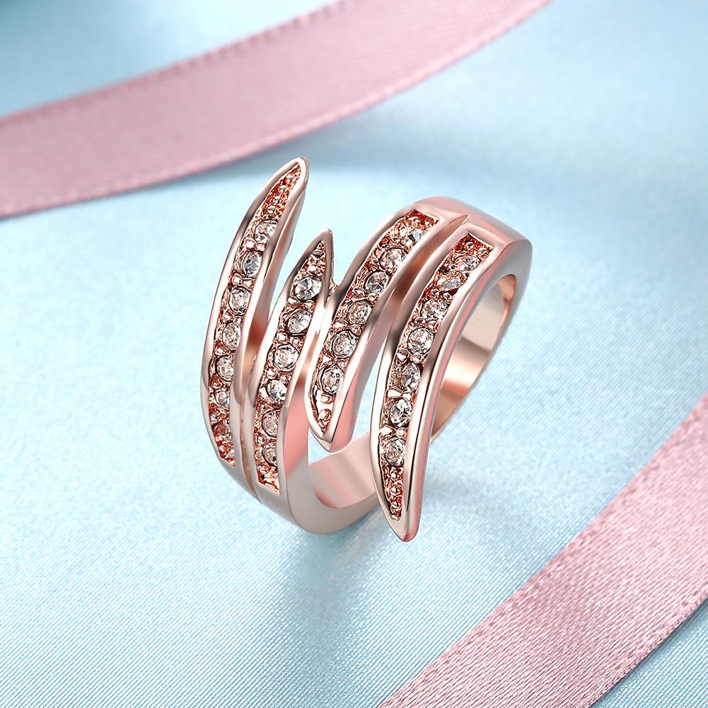 Elegant 18K rose gold plated Elements Ariana Ring featuring a curved design and white AAAAA quality stones.