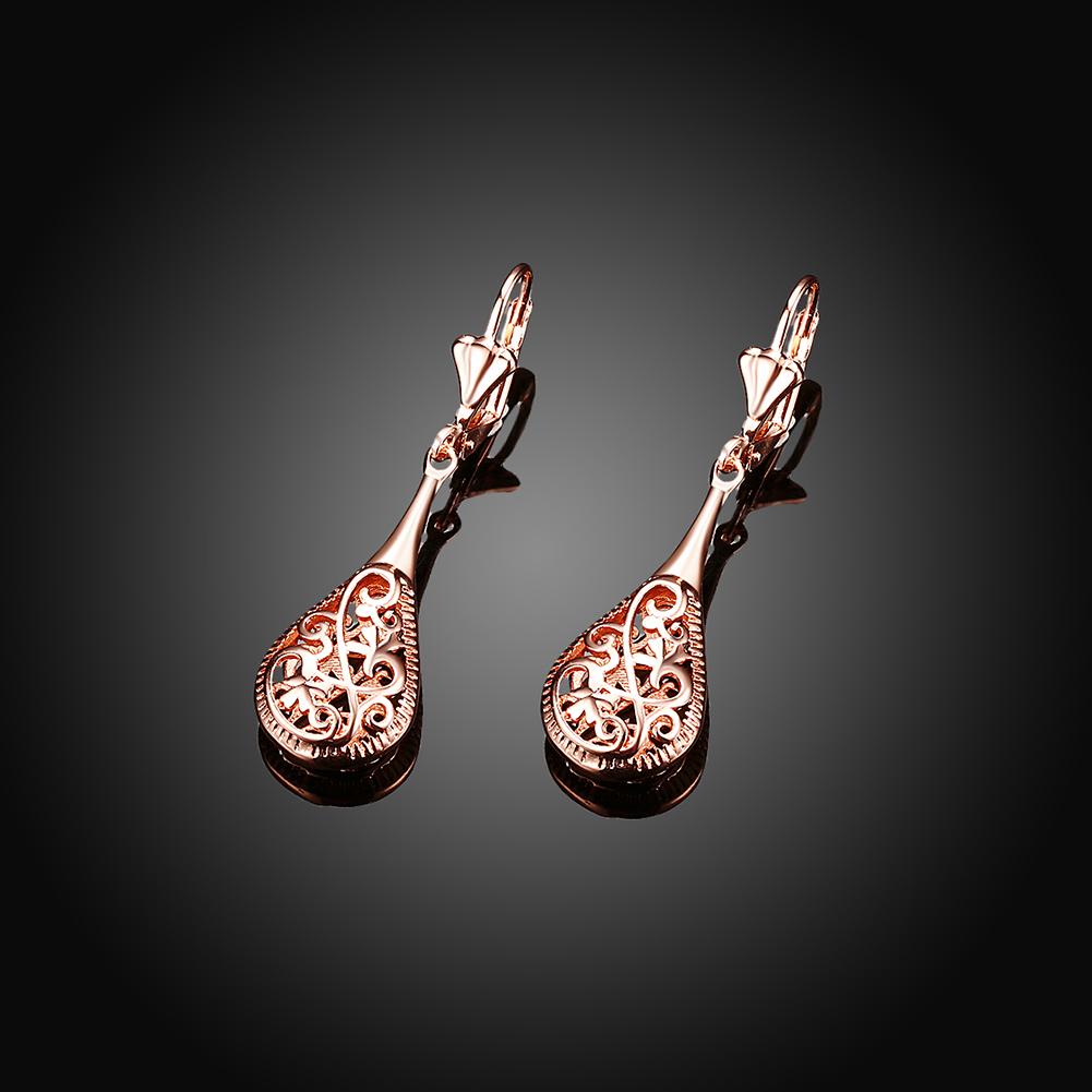 Elegant 18K rose-gold plated bohemian laser cut drop earrings showcasing intricate designs and a stylish leverback closure.