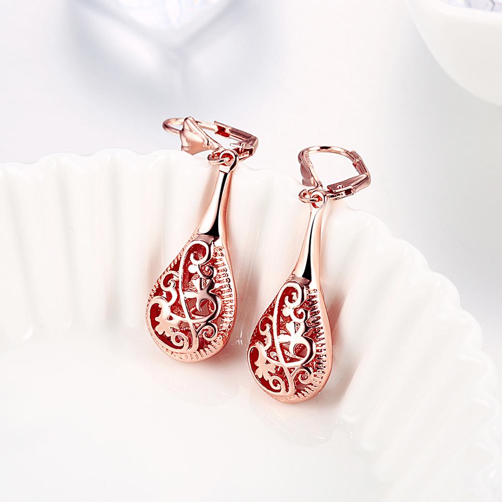 Elegant 18K rose-gold plated bohemian laser cut drop earrings showcasing intricate designs and a stylish leverback closure.