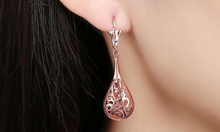 Elegant 18K rose-gold plated bohemian laser cut drop earrings showcasing intricate designs and a stylish leverback closure.