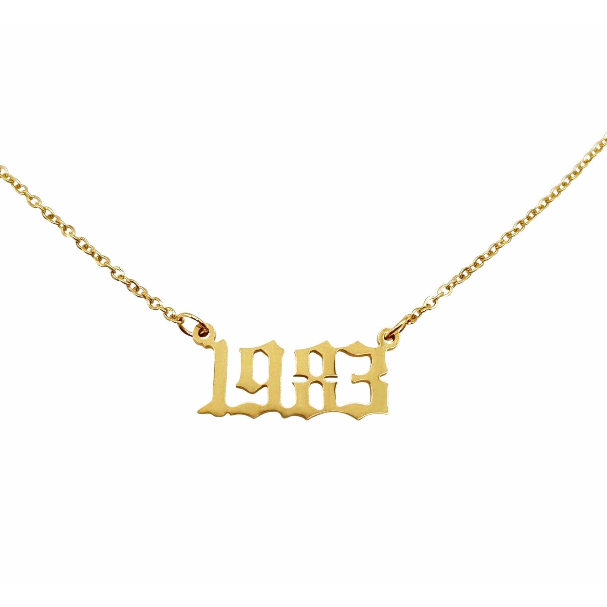 Gold necklace with "1983" pendant.
