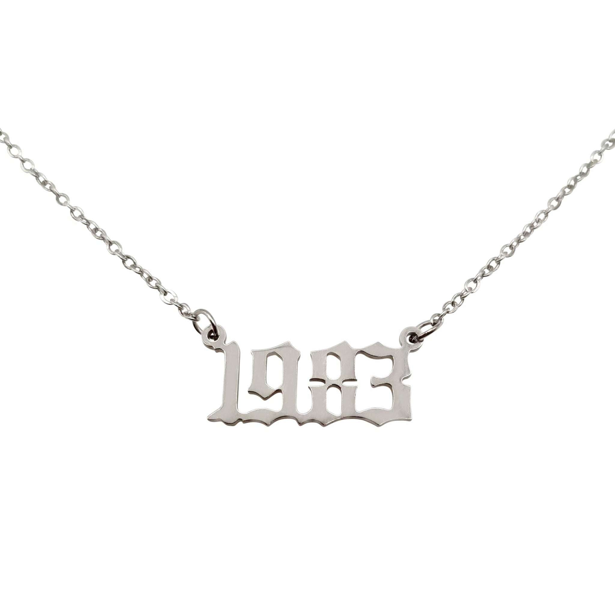 Silver necklace with "1983" pendant.