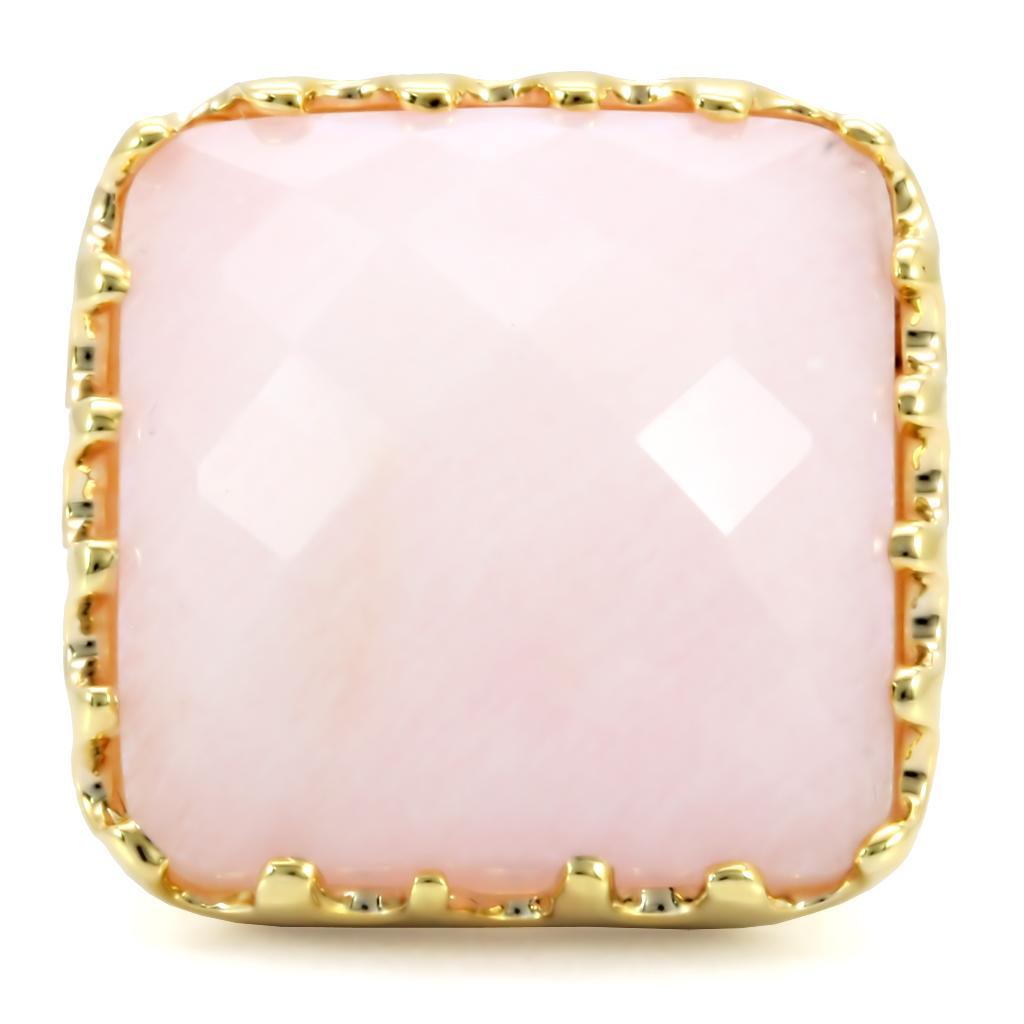 Gold brass ring featuring a rose-colored synthetic jade stone, elegantly designed for stylish wear.