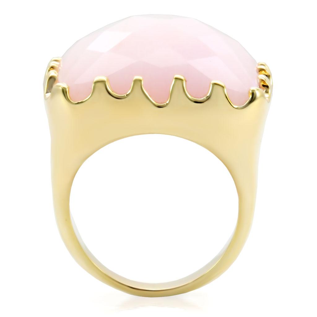 Gold brass ring featuring a rose-colored synthetic jade stone, elegantly designed for stylish wear.