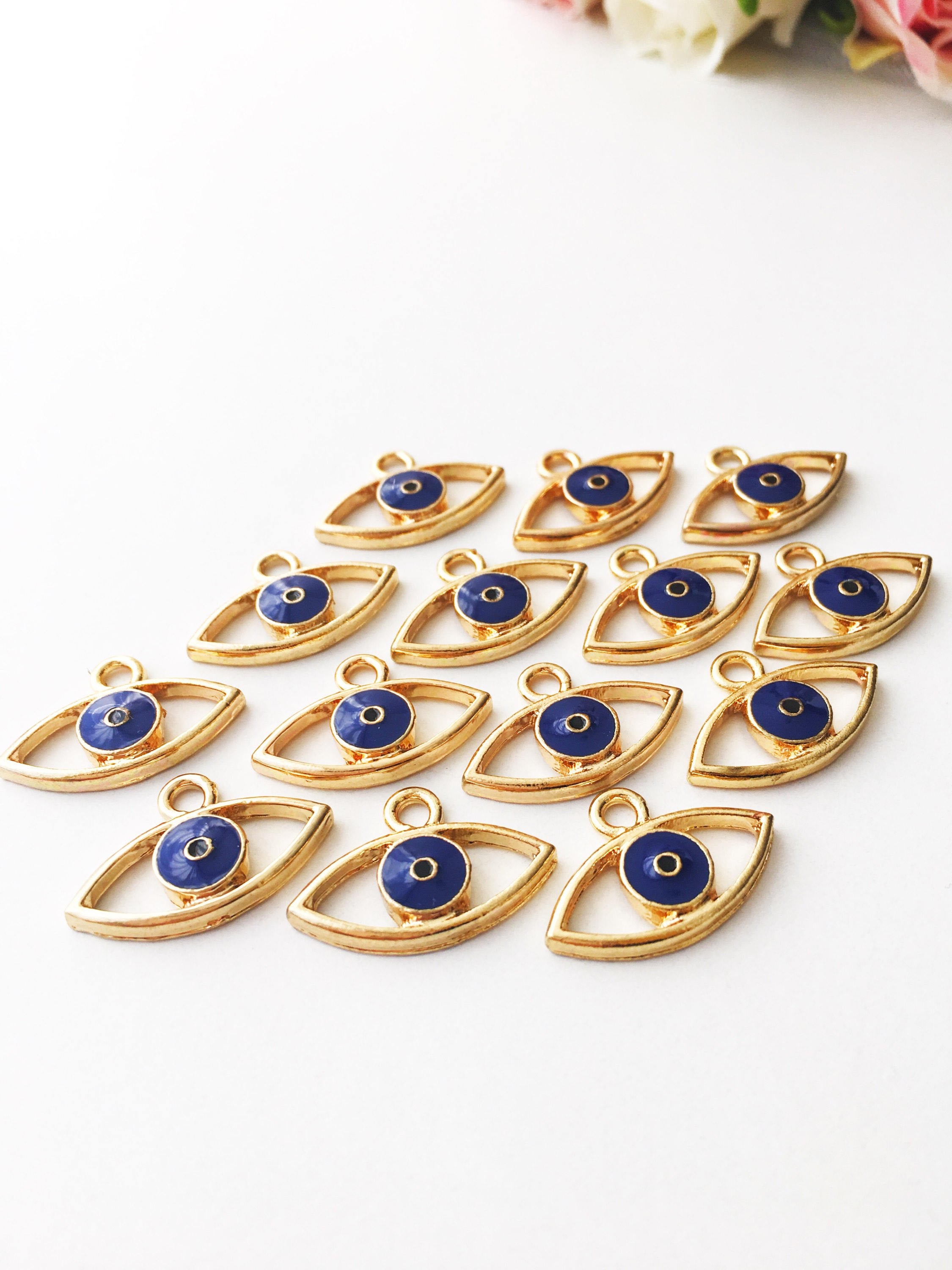 Two blue evil eye charms made of brass, featuring a 20mm size and 2mm hole, symbolizing protection and good fortune.