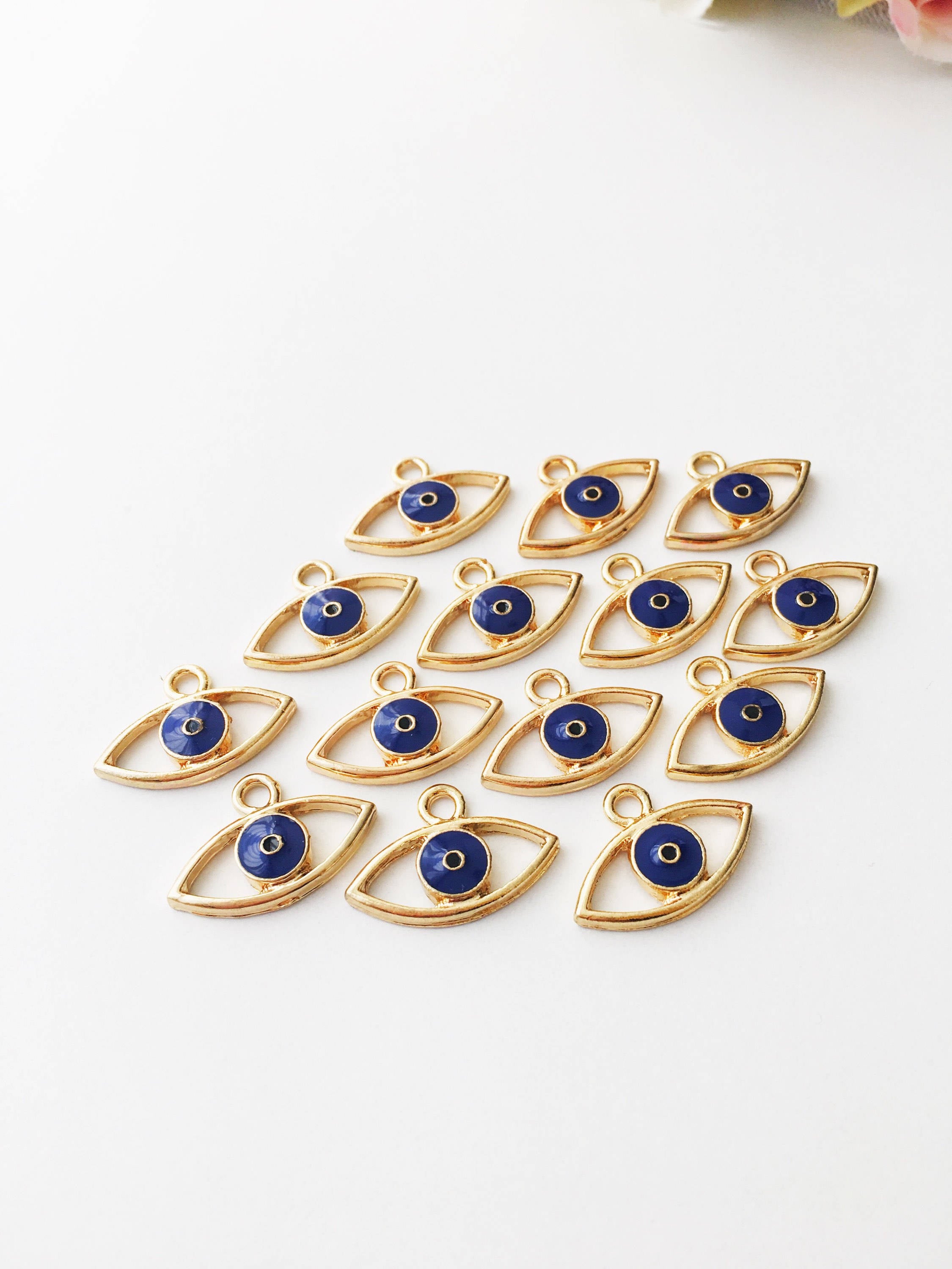 Two blue evil eye charms made of brass, featuring a 20mm size and 2mm hole, symbolizing protection and good fortune.