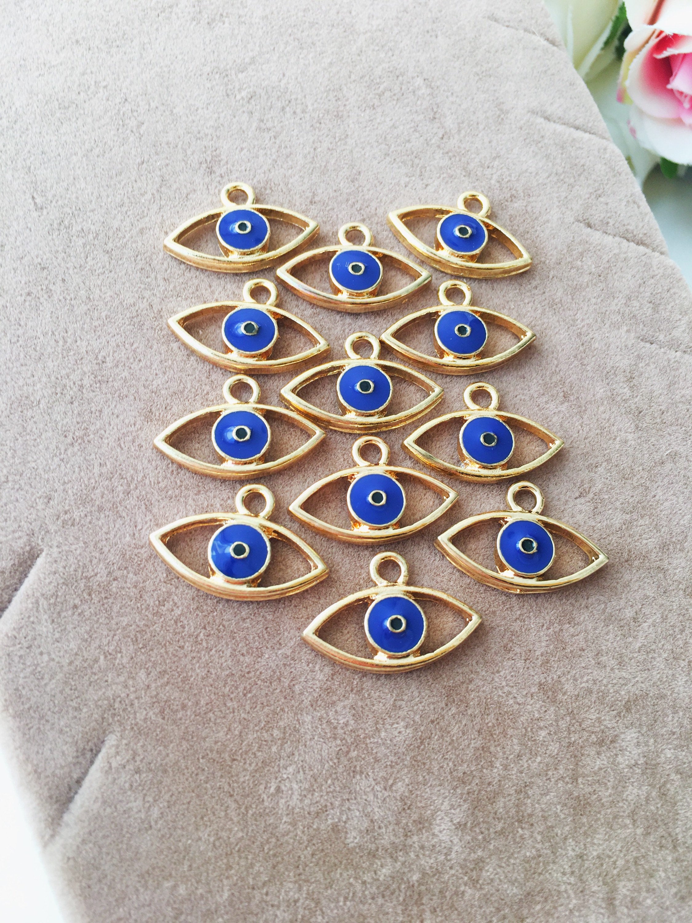 Two blue evil eye charms made of brass, featuring a 20mm size and 2mm hole, symbolizing protection and good fortune.