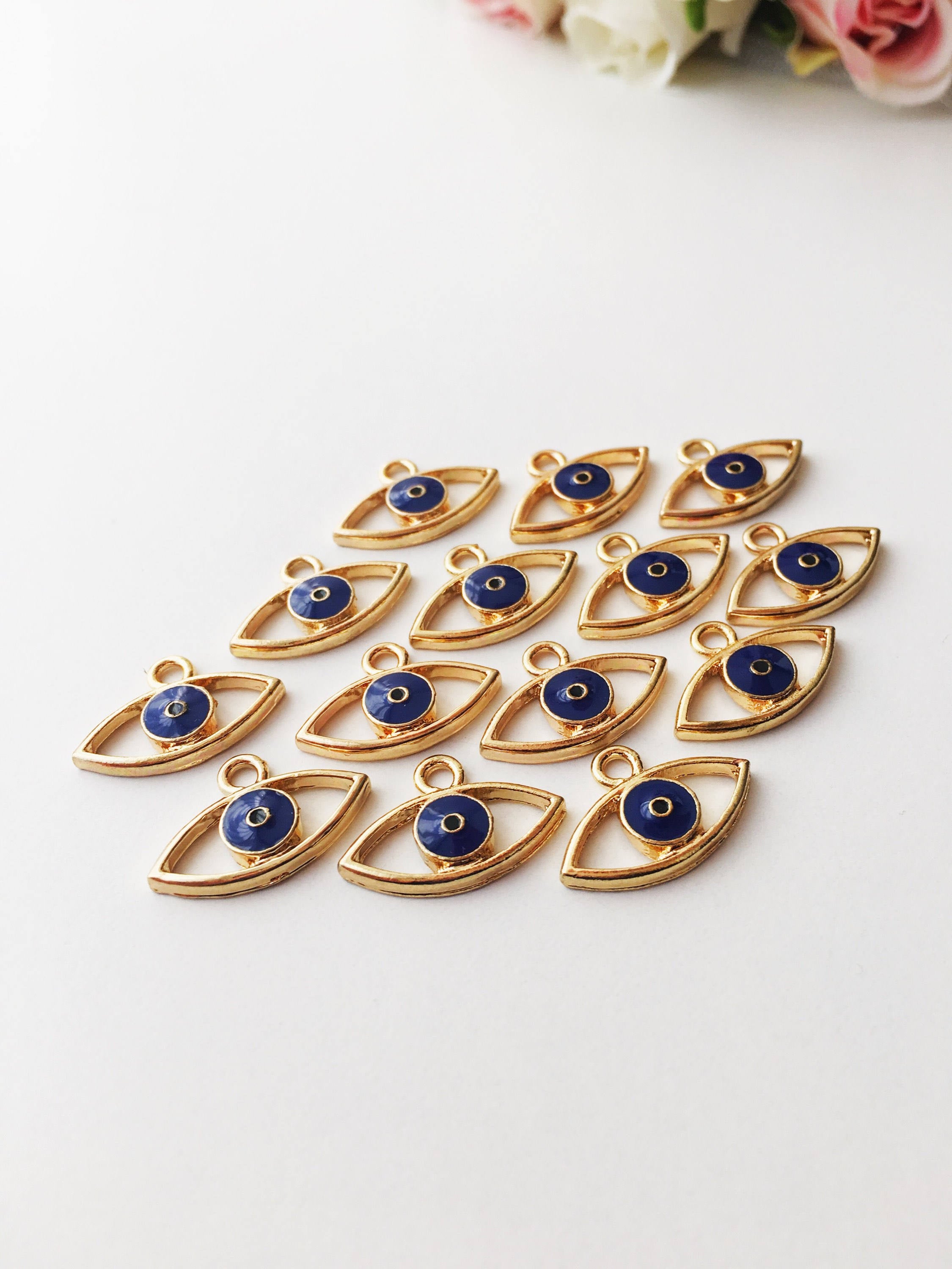 Two blue evil eye charms made of brass, featuring a 20mm size and 2mm hole, symbolizing protection and good fortune.