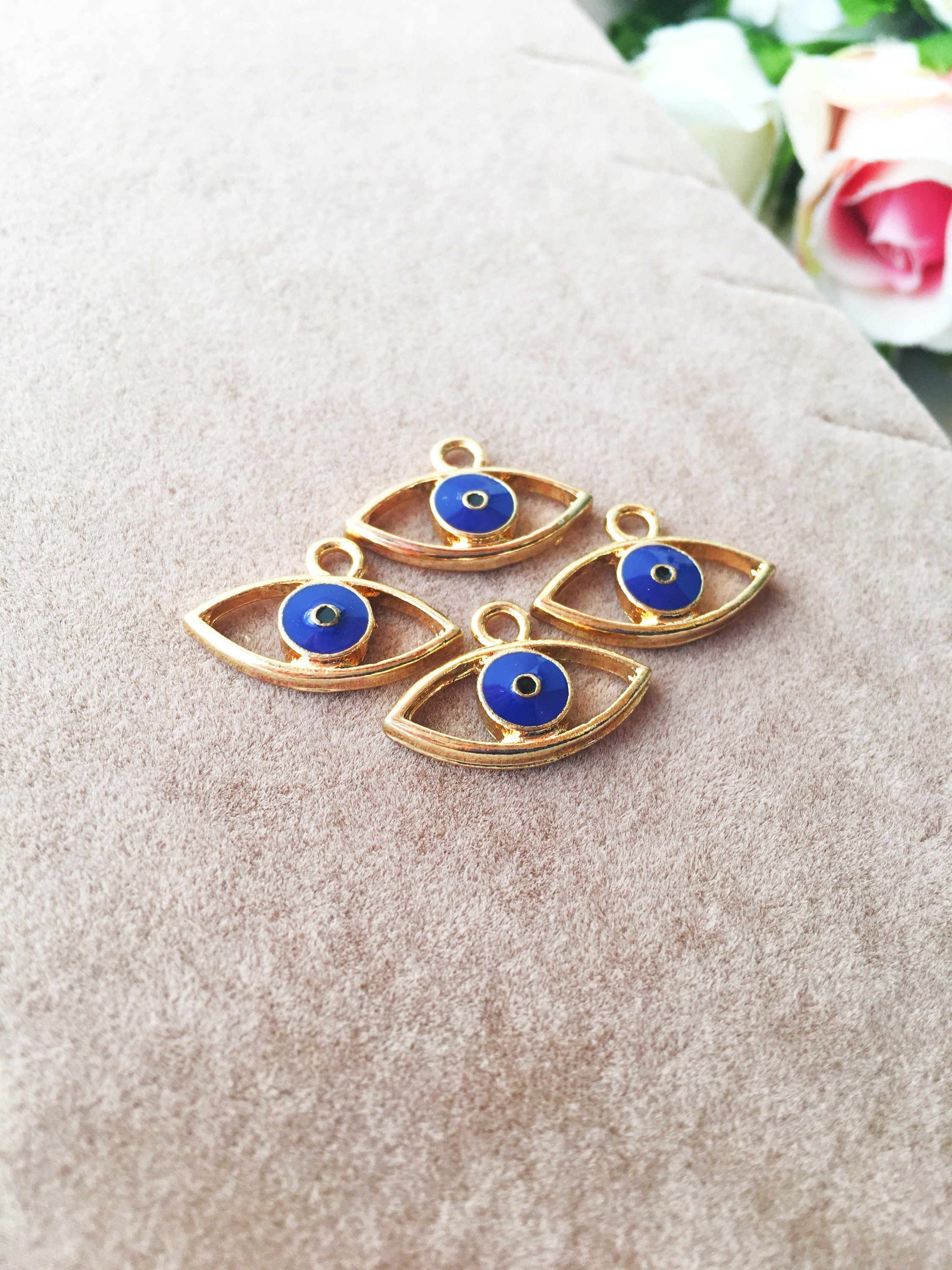 Two blue evil eye charms made of brass, featuring a 20mm size and 2mm hole, symbolizing protection and good fortune.