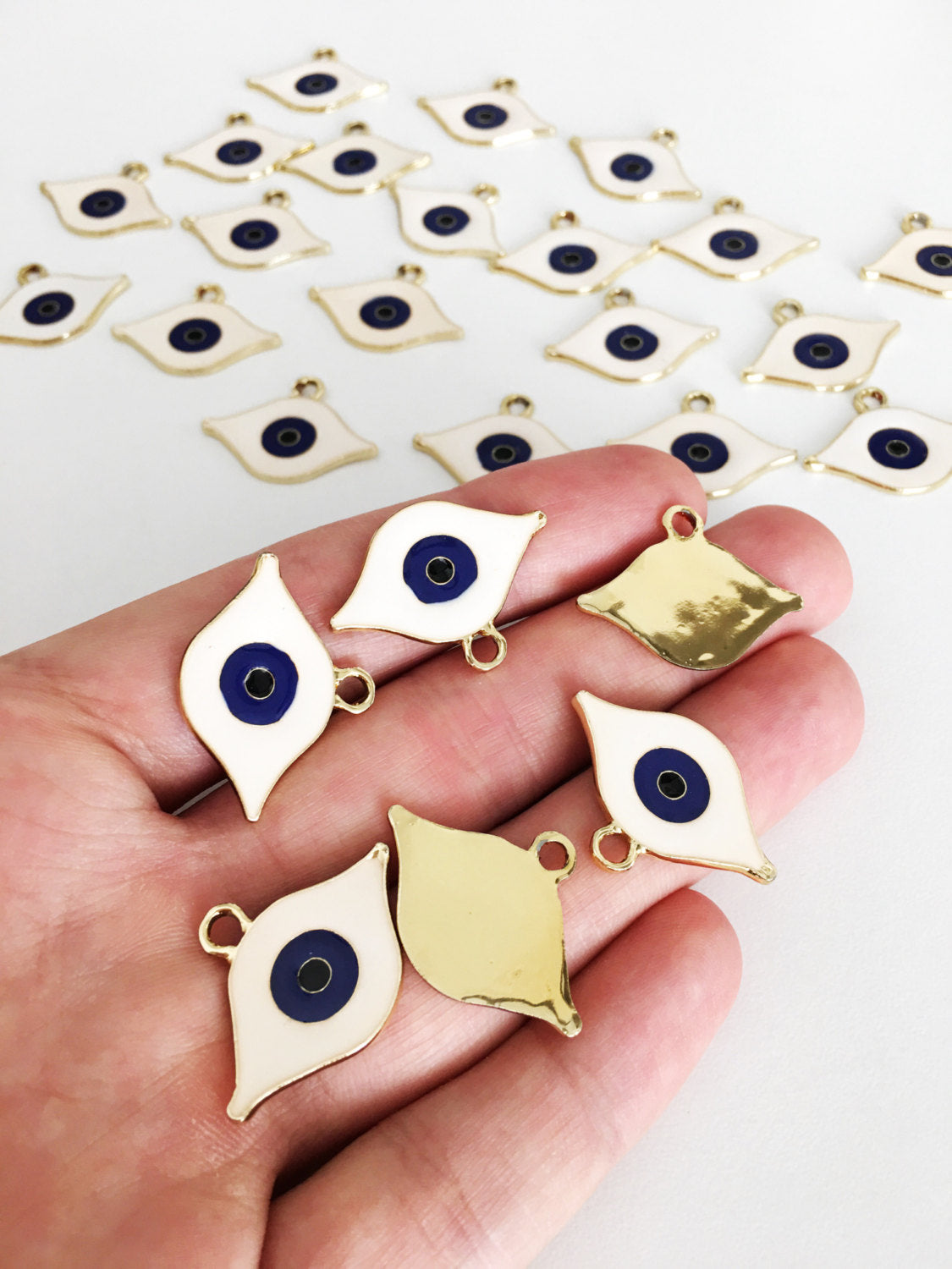 Two gold plated evil eye charms with white enamel, 20mm size, perfect for DIY jewelry.