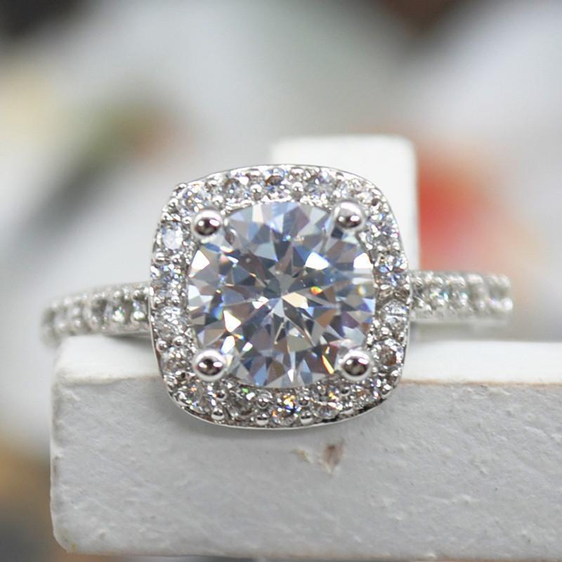 2.00 CT Cushion-Cut Queen White Elements Ring featuring a dazzling cushion-cut center stone surrounded by a halo of shimmering gemstones.